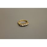 An antique 18ct gold five pearl ring, size O/P.