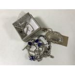 A silver whisky label, silver bracelet and chain etc.