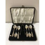 Six silver teaspoons and a silver plated sugar tong, cased.