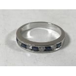 An 18ct white gold diamond and sapphire half eternity ring, size Q.
