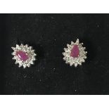 A pair of 9ct gold ruby and diamond cluster earrings.