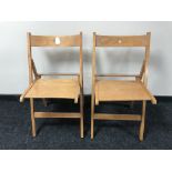 A pair of beech framed folding school chairs (2)