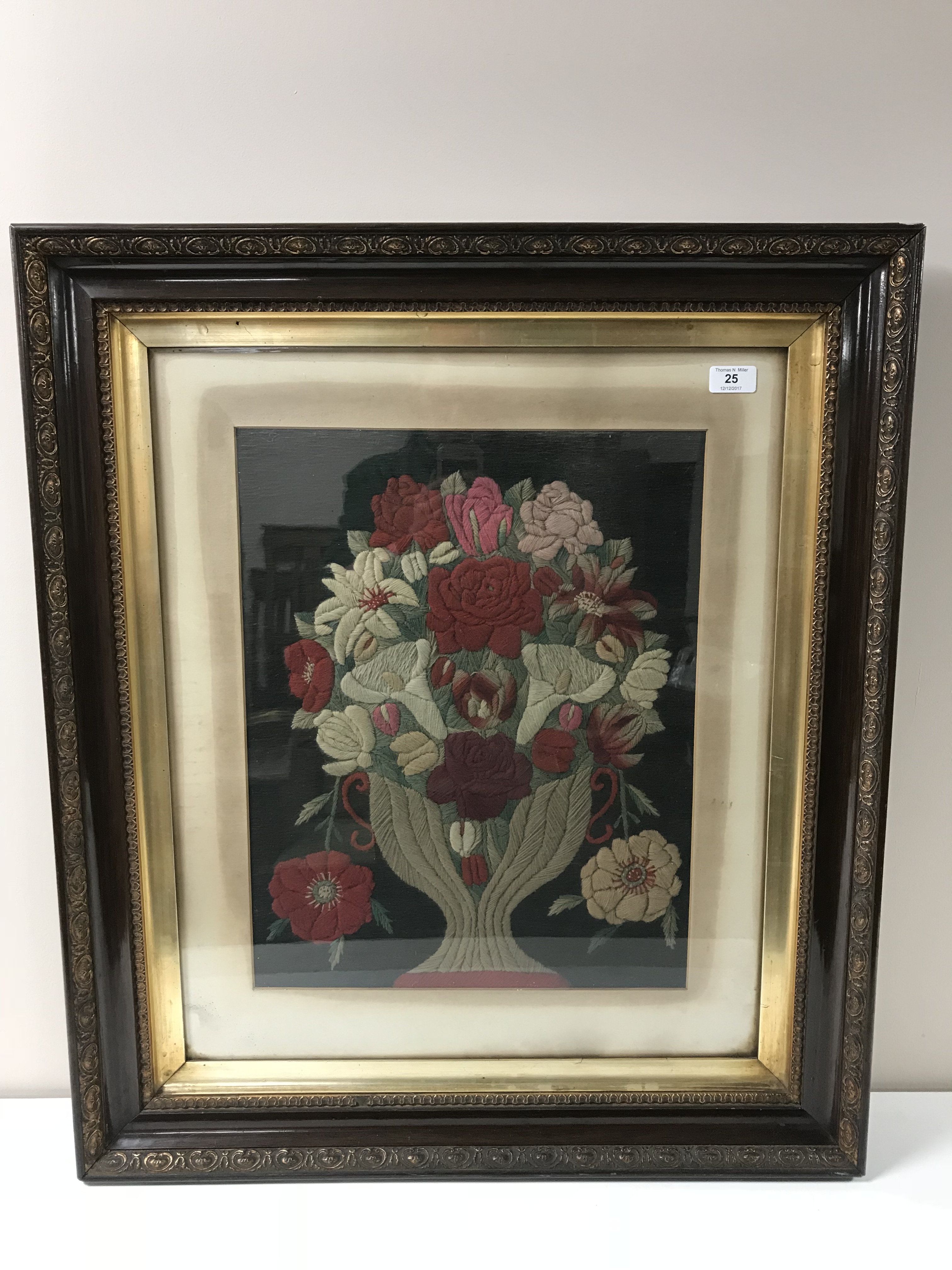 A nineteenth century crewel work panel depicting flowers in a vase, 39 cm x 50 cm, framed.