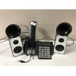 A Bang and Olufsen BeoCom 2500 telephone set together with a pair of Ravon multimedia speakers