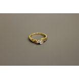 An 18ct gold two-stone diamond ring, approximately 0.2ct, size M/N.