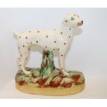 Late Staffordshire figure of a standing Dalmatian on oval naturalistic base,