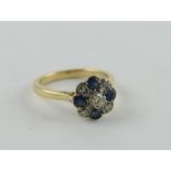 Diamond and sapphire cruciform cluster ring, in 18ct gold, 1986.