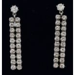 Pair of diamond drop earrings, each with a flexible row of twenty brilliants, in pairs,