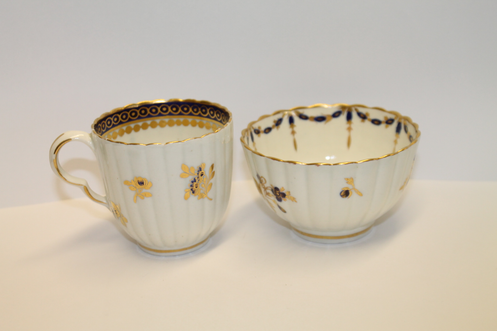 Caughley coffee cup of reeded form with gilt & blue band decoration & gilt & blue floral & foliate