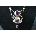 Attractive Art Nouveau silver pendant with two large and three small amethysts collet set in gold