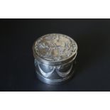 Victorian silver cylindrical box embossed with swags, the cover with equestrian figure,