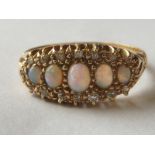 Edwardian ring with fire graduated opals and small old-cut diamonds in 18ct gold, Chester.
