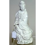 19th / 20th century Chinese blanc de chine figure of Guanyin, seated on a rocky plinth,