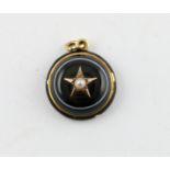 Victorian onyx and pearl cabochon pendant in gold.