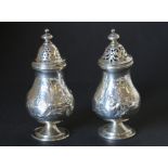 Pair of George III silver baluster pepperettes, florally embossed by R Hennell,