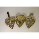 Three 19th century pierced brass trivets of heart form, one inscribed "Give Your heart to God Now",