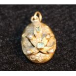 Victorian gold locket pendant with pearls and emeralds.