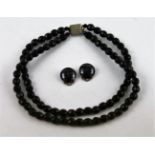 Onyx glass bead necklace and a pair of similar ear studs.