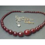 Pair of garnet earrings "9ct" a similar brooch, a silver necklet and another, processed amber.