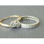 Diamond two stone crossover ring with collet set brilliants and an eternity ring with mixed cut