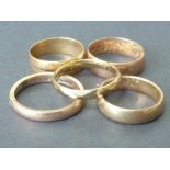 Four 9ct gold band rings and another unmarked.