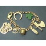 9ct gold curb bracelet with various gold and other charms.