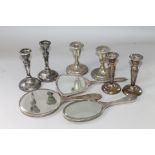 Three pairs of silver dwarf candlesticks and three toilet mirrors.