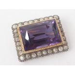 Victorian rectangular brooch with an amethyst within a border of old cut diamond brilliants in gold