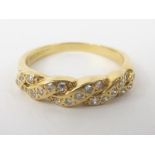 Gold ring with twisted bands of mixed cut diamonds in 18ct gold.