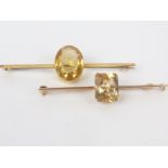 Gold bar brooch with oval citrine and another similar, rectangular.