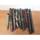 Eight vintage fountain pens and miscellaneous other pen parts.