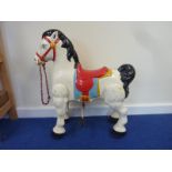 Reproduction child's hobby horse tricycle ornament in the antique style.