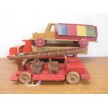 Three vintage wooden pull along toy vehicles including Wegenbouw wagon,