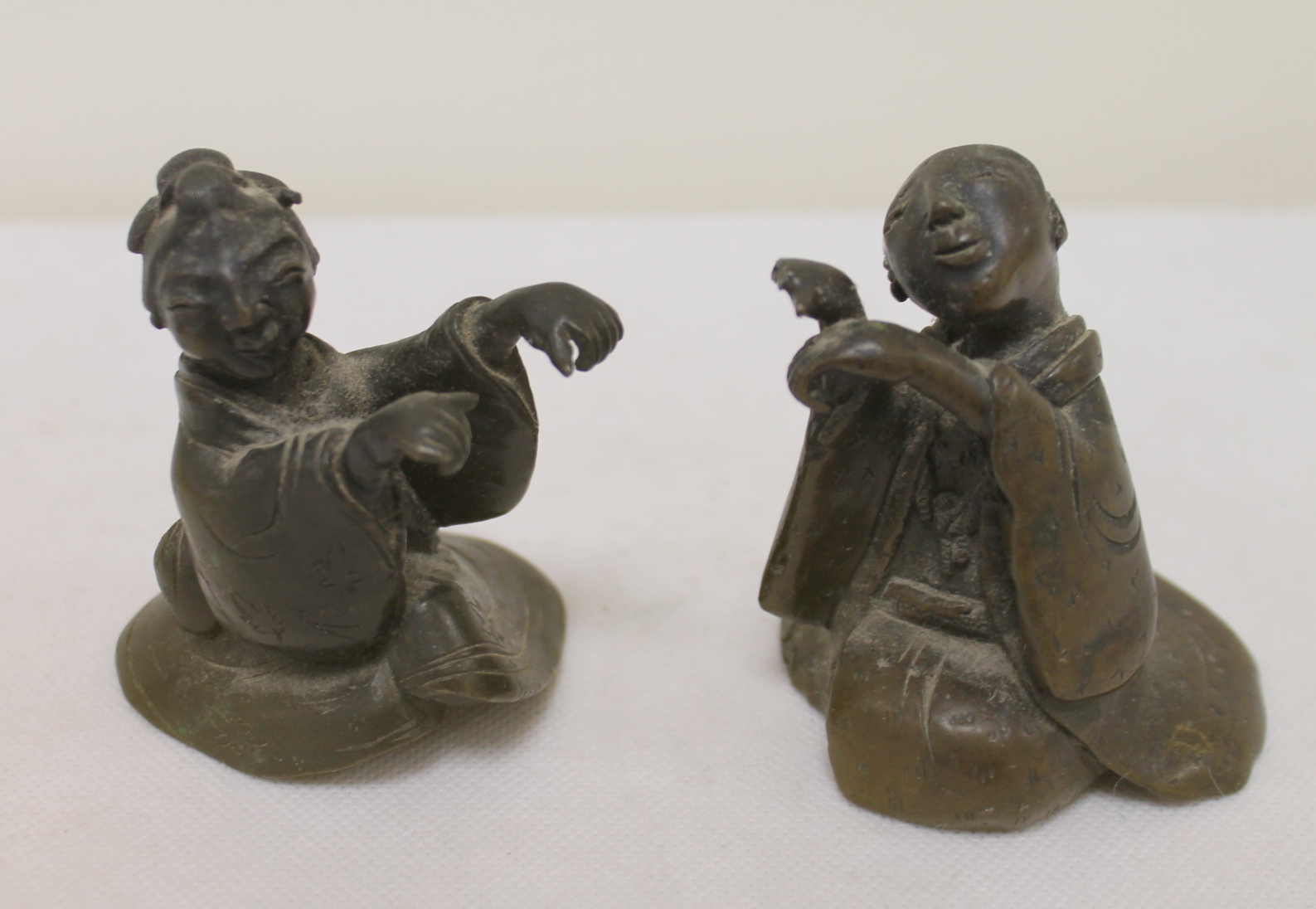 Pair of Meiji period Japanese bronze figures of a geisha and her companion,