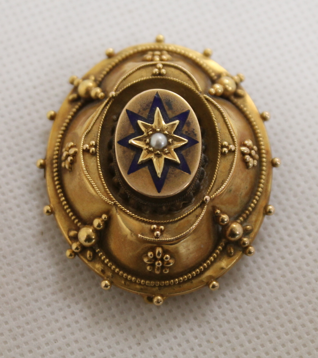 Victorian gilt metal brooch with seed pearl set in blue enamel star motif and locket back