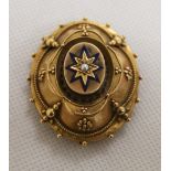 Victorian gilt metal brooch with seed pearl set in blue enamel star motif and locket back