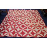 Large vintage American red and white pieced patchwork quilt with geometric design,