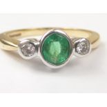 Three stone ring with collet set emerald and two diamonds in 9ct gold. Size "J1/2".