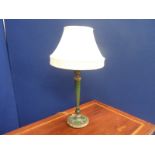 Art Deco style turned wood table lamp painted with geometric designs on green ground, 60cm high.
