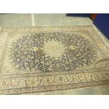 Large Hamadan Iranian carpet with repeating floral pattern on blue and ivory ground.