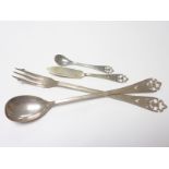 Silver pickle spoon and fork with pierced thistles and a single mustard spoon and a butter knife.