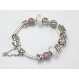 Pandora bracelet with red paste silver and other charms. Condition Report. Approx.
