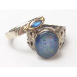 Opal doublet ring and another with moonstone in silver and gold.