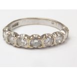Diamond seven stone ring of half eternity style, 18ct white gold, 1977. Size "L1/2".