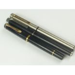 A Sheaffer steel fountain pen, another black and a Pelikan pen.