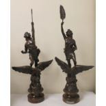 Pair of French bronzed spelter classical figures with eagles on rocky plinth bases,