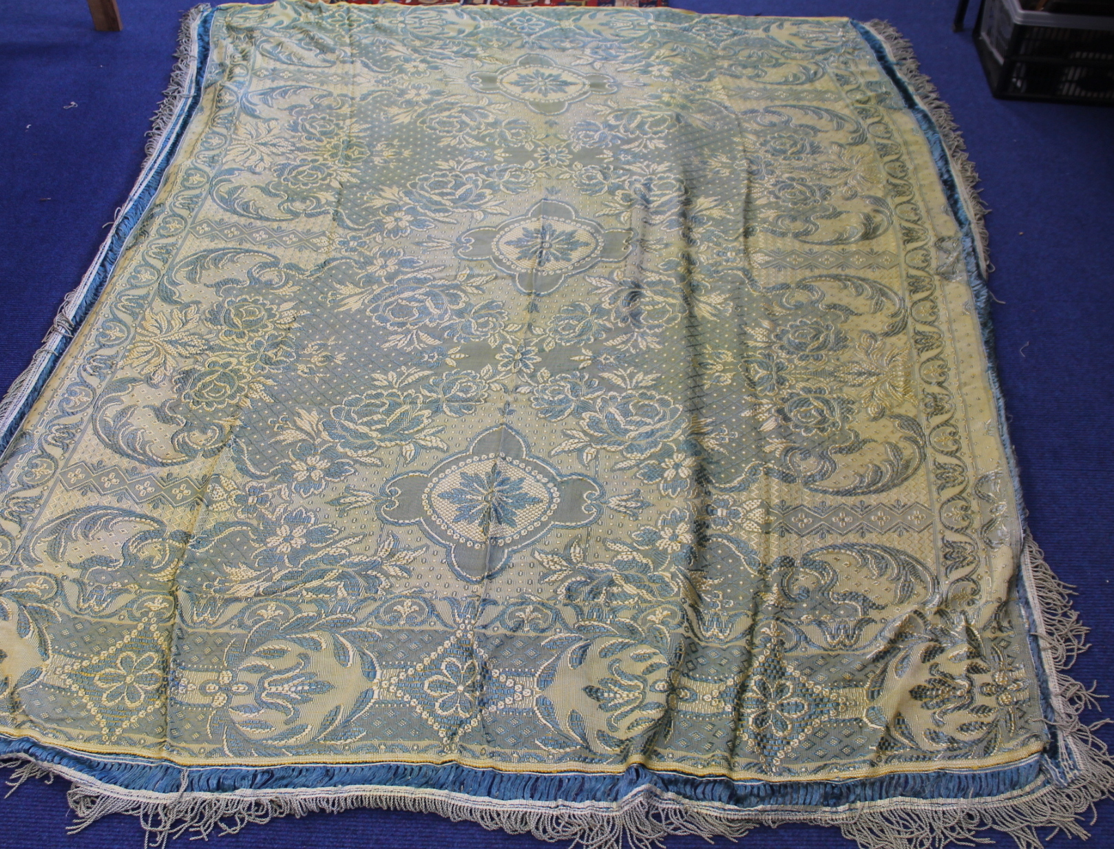 Early 20th century vintage floral woven bedspread in yellow and blue with fringed borders,