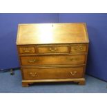 George III cross banded oak bureau with fitted interior above three short and two long drawers on