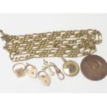 Seven gold and other items, a rolled gold necklet and a copper token.