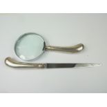 Magnifying glass and paperknife with silver pistol handle.